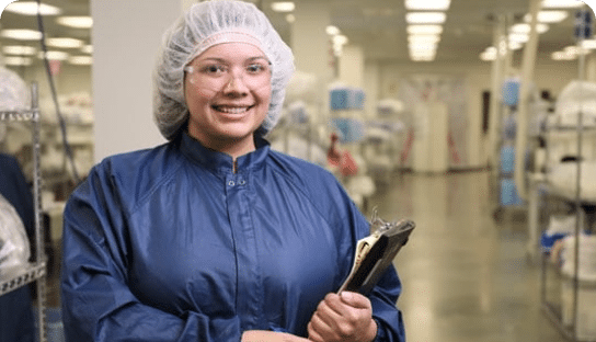 Image of smiling woman in clean room gown