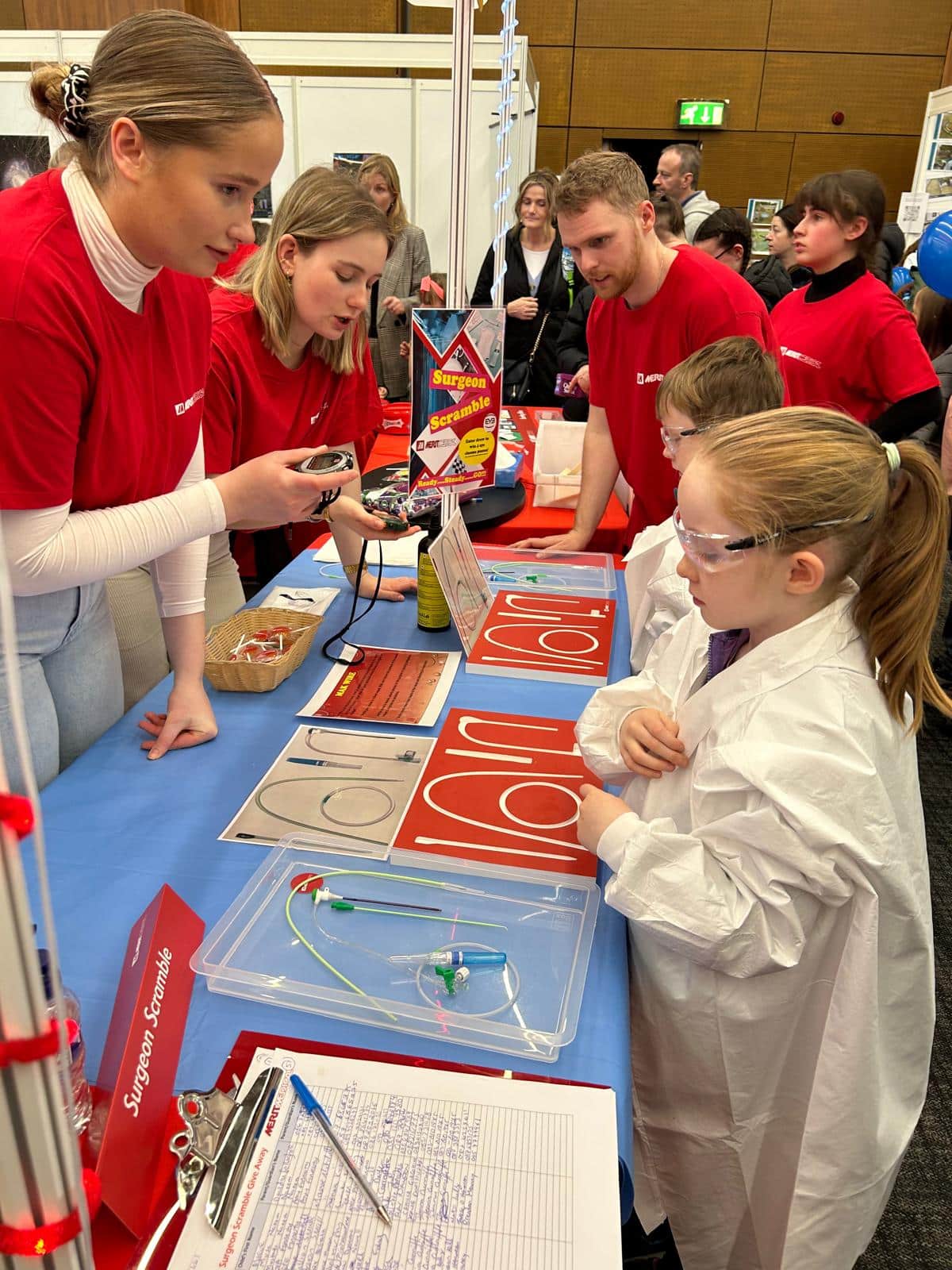 Science Festival - students in labcoats working with Merit employees